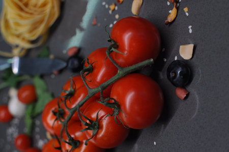 Fresh tomatoes in a plate on a dark background. Harvesting tomatoes. Top view. High quality photoの写真素材