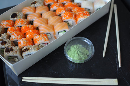 japanese sushi food. Maki ands rolls with tuna, salmon, shrimp, crab and avocado. Top view of assorted sushi. Rainbow sushi roll, uramaki, hosomaki and nigiri. . High quality photoの写真素材