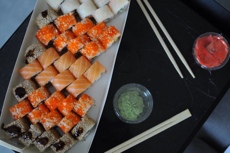 japanese sushi food. Maki ands rolls with tuna, salmon, shrimp, crab and avocado. Top view of assorted sushi. Rainbow sushi roll, uramaki, hosomaki and nigiri. . High quality photoの写真素材
