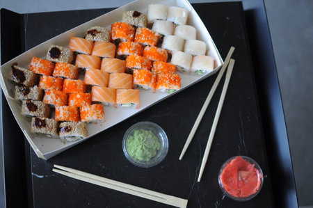japanese sushi food. Maki ands rolls with tuna, salmon, shrimp, crab and avocado. Top view of assorted sushi. Rainbow sushi roll, uramaki, hosomaki and nigiri. . High quality photoの写真素材