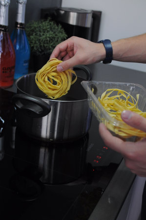 pasta with tomatoes and basil on a white background. Fork with pasta flying on a white background with tomatoes. High quality photoの写真素材