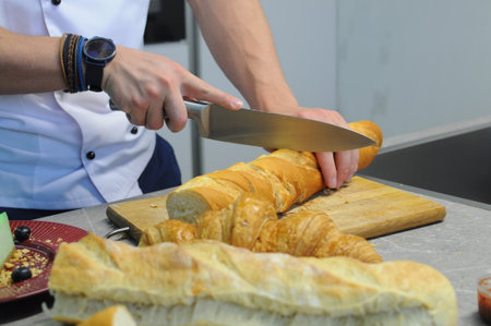 Chef's hands cut bread Close-up. High quality photoの写真素材