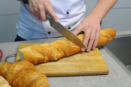 Chef's hands cut bread Close-up. High quality photoの写真素材
