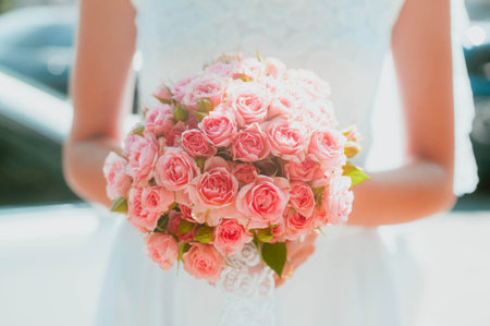 Bright Beautiful bridal bouquet with roses and ribbon. High quality photoの写真素材