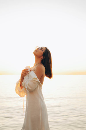 Beach holiday - woman walking on sunny, tropical beach in the morning . High quality photoの写真素材