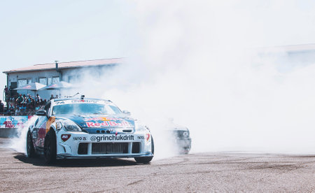 Race car drifting on speed track, Professional driver drifting car on race track with smoke, Abstract texture and background black tire tracks skid on asphalt road, Wheel tire tracks background. High quality photoの写真素材