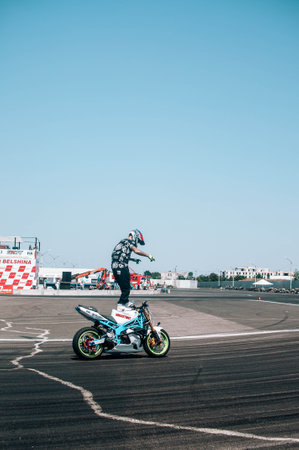 Biker in a black uniform driving a red sports motorcycle on a curvy road High quality photoの写真素材