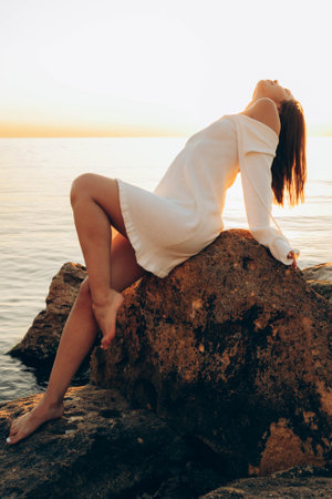 Beach holiday - woman walking on sunny, tropical beach in the morningの写真素材