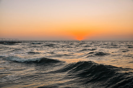 Sunset at the beach. Cloudy sunset and pier. . High quality photoの写真素材