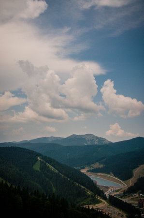 Beautiful green mountains with cloudy sky background. Summer vacation. Mountain landscape.の写真素材