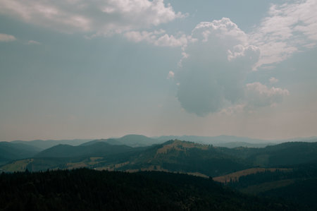 Beautiful green mountains with cloudy sky background. Summer vacation. Mountain landscape.の写真素材