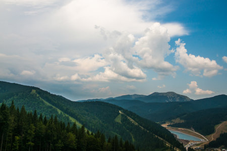 Beautiful green mountains with cloudy sky background. Summer vacation. Mountain landscape.の写真素材