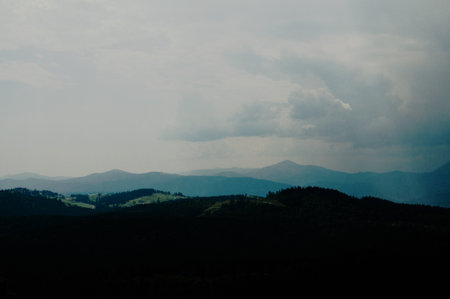 Beautiful green mountains with cloudy sky background. Summer vacation. Mountain landscape.の写真素材