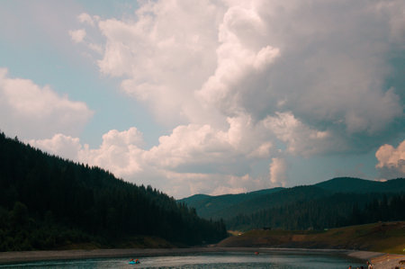 Beautiful green mountains with cloudy sky background. Summer vacation. Mountain landscape.の写真素材