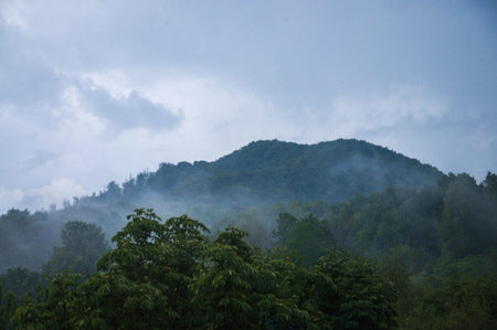 Beautiful green mountains with cloudy sky background. Summer vacation. Mountain landscape.の写真素材