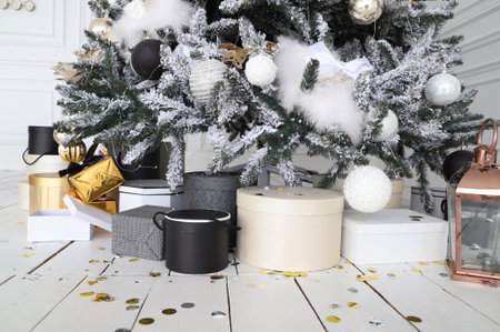 Close-up of Christmas presents in wrapping paper are on the floor under the Christmas treeの写真素材