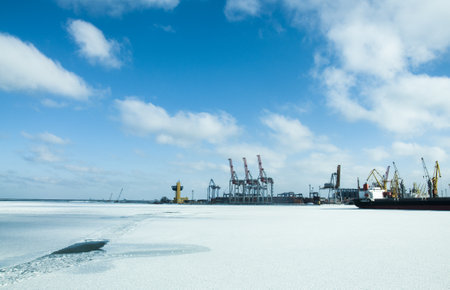 Winter shipping. Big cargo ships in frozen ice sea fairwayの写真素材