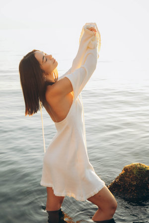 Beach holiday - woman walking on sunny, tropical beach in the morningの写真素材