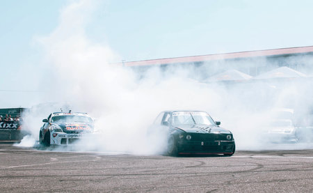 Race car drifting on speed track, Professional driver drifting car on race track with smokeの写真素材