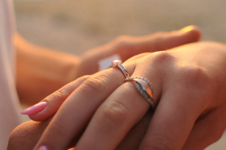 Close up of young couple hold hands showing love and careの写真素材