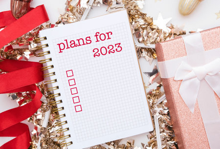 Mock up of notepad or copybook with written text - plans for 2023. Check box to do. High quality photo like a postcardの写真素材