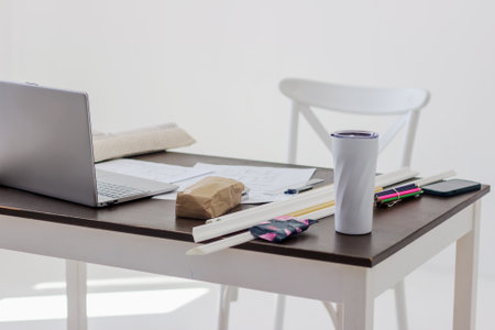 Side view of interior designer or architect workplace with a blueprint for new project, daytime....