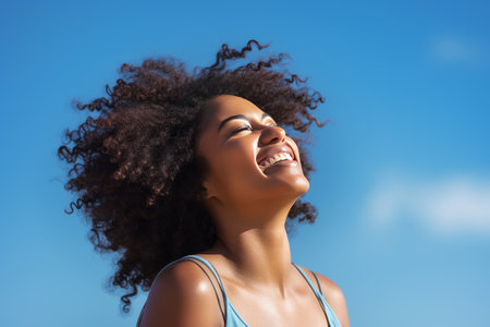 Stock photography of a black African American woman. Mind. Launching, blue sky background.の素材