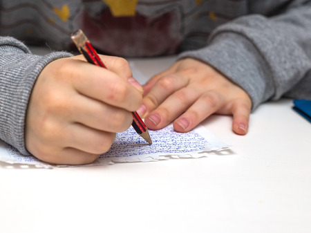 young girl writing on the paperの写真素材