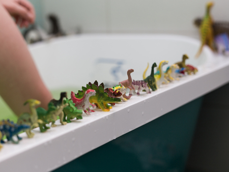 a lot of different toy dinosaurs at the bathroomの写真素材