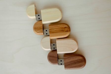 set of wooden brown usb flash drive, wooden packaging. Light and dark wood, data storage, beautiful photo feedback to the client. set for the photographer, presentable of photos, luxuryの写真素材