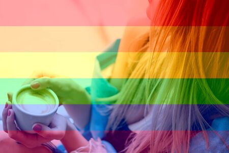 lonely blonde girl sitting on a windowsill with a white cup with coffee with a heart, romantic mood. LGBT natural pattern, Vintage texture background, Abstract paintingの写真素材