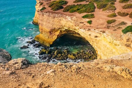 cliffs on the famous Benagill beach in Portugal, waves crashing on cliffs, the raging ocean