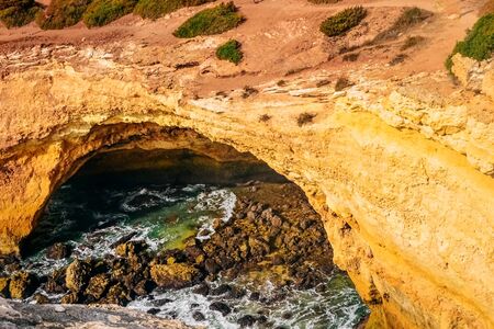 cliffs on the famous Benagill beach in Portugal, waves crashing on cliffs, the raging ocean
の写真素材