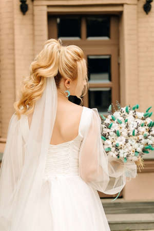 beautiful slender blonde bride with gentle hairstyleの写真素材
