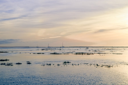 Beautiful sky in the bay in the city of Faro in Portugal. Colors of nature at sunset by the waterの写真素材