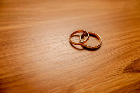 Golden rings lie on a wooden table