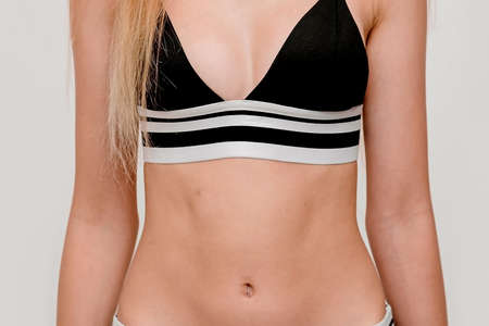 slim girl, small breasts teenage girl in black swimsuitの写真素材