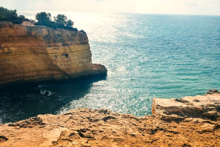 Rocks on the coast of Benagil beach in Lagoa. Top view of the atlantic ocean in portugalの写真素材