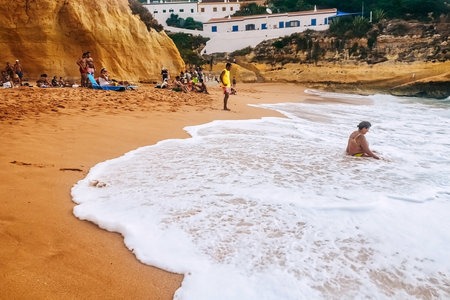Benagil, Portugal - 05/19/2020: big fat woman drowning in water on benagil beach in portugalのeditorial素材