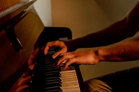 male hairy hands, guy playing piano, fingers close up, horizontal imageの写真素材