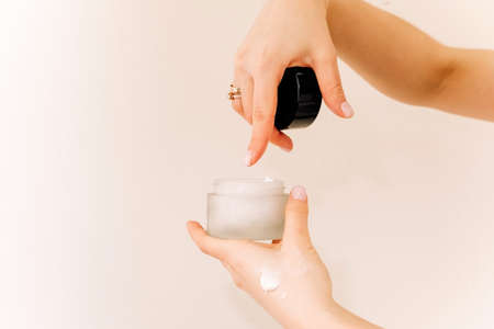 girl holding a jar of cream. testing and advertising of products, care cosmetics, horizontal imageの写真素材