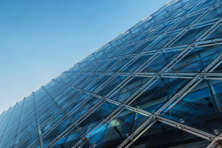 Abstract image of a modern architecture background, building made of glass on a blue sky backgroundのeditorial素材