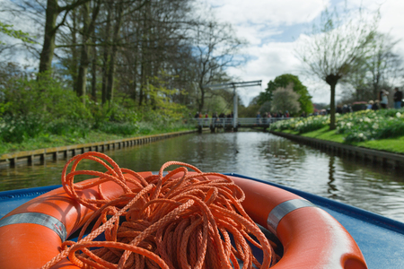 LISSE, NETHERLANDS - April 22, 2017: View from the traveling boat in the cannal in the Keukenhof flower park. Selective focus.のeditorial素材
