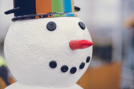 Snowman with a pot on his head. Cloudy day.の写真素材