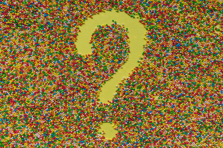 Question mark symbol written in sprinkles. Sweets, sugar, diet and celebration concept.の写真素材