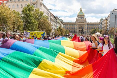 Prague, Czech Republic - August 11, 2018: People holding huge rainbow flag ot the Prague Gay Pride parade. Crowd on Wenceslas Square in front of the National Museum.のeditorial素材