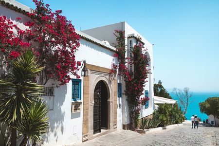 Sidi Bou Said, Tunisia - May 19, 2017: View of the street and sea in the background. Blue sky, copy space.のeditorial素材
