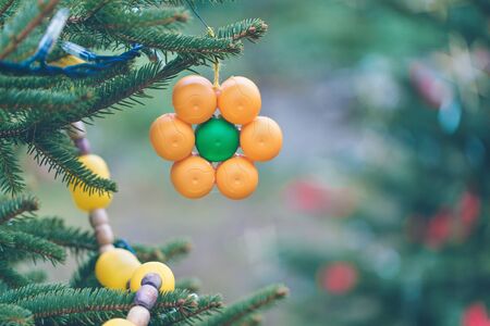 Handmade decoration on a Christmas tree. Diy ideas for children. Environment, recycle and zero waste concept. Selective focus, copy space.の写真素材
