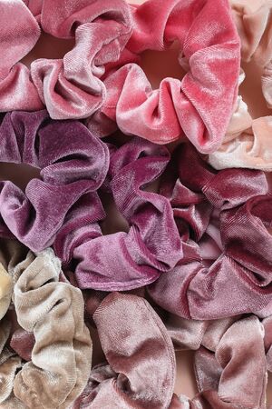 Collection of trendy velvet scrunchies on pink background, close up. Diy accessories and hairstyles concept.の写真素材