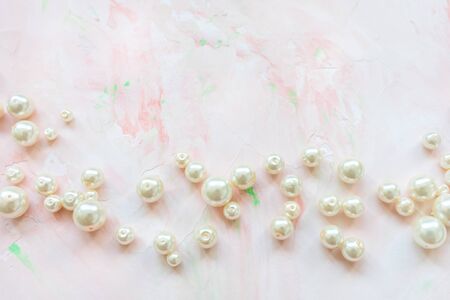 White pearls on pink creative abstract backround. Flat lay, top view, social media hero header template, lifestyle concept, copy spaceの写真素材